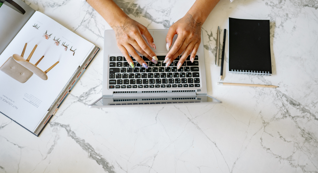 Person typing on a laptop keyboard